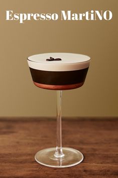 an empty martini glass with the word espresso martini on it's side