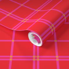 a red and pink plaid wallpaper with a white circle in the center on it