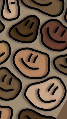 an image of many different colored smiley faces on a surface that looks like it is made out of paper