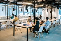 people sitting at tables in an office setting