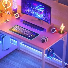 a desk with a computer and headphones on it