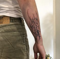 a person with a small tattoo on their arm holding a piece of food in his hand