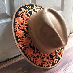 Stand out with this beautiful handcrafted Mexican Suede Hat with beautiful detailed floral embroidered canvas brim. Perfect accessory to add that with that daily outfit. MADE IN MEXICO By: Mexican Artisans For: Women Size: Medium 23' Color: tan | black | orange Details: Top Suede Embroidered canvas brim Inner elastic band Contact us for more details PLEASE READ BEFORE PURCHASE: The picture is an ACCURATE REPRESENTATION.Colors in the pictures may vary a little by effects of light. Each product is Embroidered Brown Cap, Brown Embroidered Hat, One Size, Traditional Fedora For Festivals, Spring Festival Embroidered Hat, Embroidered Brimmed Spring Hats, Spring Embroidered Fedora Hat, Artisan Adjustable Hats For Spring, Bohemian Flat Brim Felt Hat For Spring, Spring Embroidered Brimmed Hat