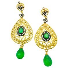 The handmade filigree faux emerald green earrings is ornate and lovely, it is further enhanced by sparkling CZ stones. Earrings have a post closure for pierced ears. Length: 2 3/4 inches Width: 1 1/2 inches Green Luxury Pierced Earrings, Luxury Green Pierced Earrings, Green Luxury Earrings, Luxury Green Hand-set Earrings, Luxury Green Teardrop Earrings, Green Pierced Earrings For Formal Occasions, Green Hand-set Earrings For Gift, Green Hand Set Earrings For Gift, Formal Green Pierced Earrings