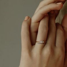 a close up of a person wearing a diamond ring