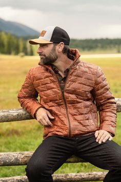 Embrace the spirit of adventure with the Teton Leather Jacket, a tribute to the rugged majesty of Wyoming’s Teton Mountain Range. Its rich, full-grain leather evokes the grandeur of these storied peaks, making a statement that is both daring and refined—striking the perfect balance between boldness and restraint. Crafted from premium full-grain sheep leather that develops a handsome patina with wear, the jacket features a modern brick-stitch pattern for a contemporary update. The lightweight dow Winter Outdoor Leather Jacket, Winter Leather Jacket For Outdoor, Brown Leather Jacket With Padded Collar For Outdoor, Brown Quilted Jacket For Outdoor Winter Use, Brown Quilted Jacket For Winter Outdoor, Leather Quilted Jacket For Fall, Rugged Brown Outerwear With Padded Collar, Rugged Fall Outerwear With Padded Collar, Rugged Fall Sport Coat For Hunting