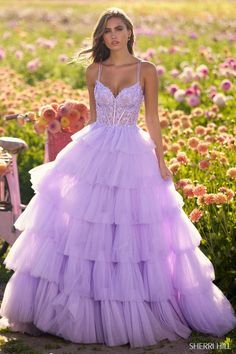 Look for your personal Wonderland in this Fantasy Inspired Spring 2024 Prom Dress by Sherri Hill! Style 56192 transcend this plane taking you to a fairytale full of lace and tulle! The ballgown silhouette is enhanced by tiered tulle layers on the full skirt. A show stopping sheer bodice is covered in lace with exposed boning, double straps, and a lace-up back. Wear this ball gown for your Prom, Ball, or Spring Formal! Prom Vibes, Ruffle Tulle Dress, Black Quinceanera Dresses, Tulle Ballgown, Red Quinceanera Dresses, Quinceanera Dresses Blue, Purple Things, Ethereal Dress, Prom Inspo