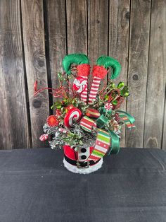 a christmas arrangement in a candy cane holder