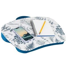 a cell phone sitting on top of a desk next to a notebook and pencil holder