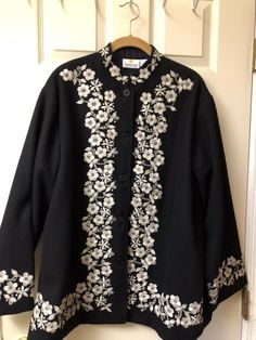 100% Wool Jacket Womens Size Large Black with taupe embroidery flowers around collar, down front and at cuffs. Also a medallion on back. 29” l, 26” pit to pit , 22.5” sleeve, Nehru collar, 100%wool, beautiful striking jacket, 5 buttons, lined. Very good condition, gently worn. Made in India for the Smithsonian Institute. From the 90’s. Embroidery Coats For Women, Embroidered Winter Outerwear With Stand Collar, Embroidered Stand Collar Outerwear For Fall, Winter Outerwear With Floral Embroidery And Stand Collar, Casual Outerwear With Floral Embroidery And Stand Collar, Black Embroidered Winter Outerwear, Long Sleeve Outerwear With Floral Embroidery For Fall, Fitted Outerwear With Floral Embroidery And Stand Collar, Black Embroidered Long Sleeve Outerwear