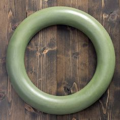 a green circular object sitting on top of a wooden table