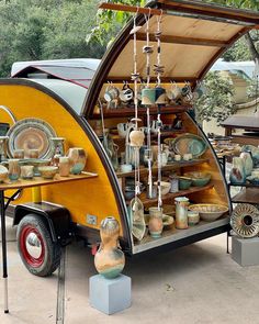 an old fashioned camper has been converted into a display area for antiques and decorative items