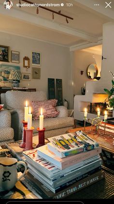 a living room filled with lots of furniture and books on top of a coffee table