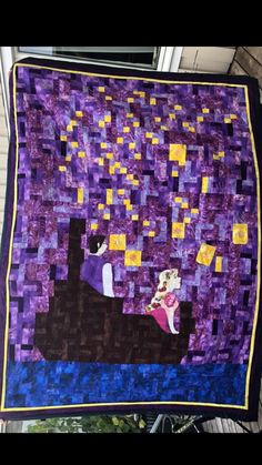 a quilt made to look like the starry night with a man and woman on a boat