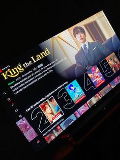 an image of the king of the land website displayed on a computer screen in dark room