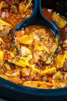 a slow cooker filled with meat and vegetable stew, ready to be cooked in the crock pot