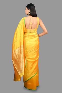 Canary yellow banarasi handloom saree crafted in pure chanderi silk with bloom buta woven details and contrasting green border detailing. Comes with an unstitched blouse piece. - Aza Fashions Yellow Chanderi Handloom Blouse, Yellow Handloom Chanderi Blouse, Yellow Slub Silk Traditional Wear With Unstitched Blouse, Fitted Yellow Raw Silk Blouse Piece, Fitted Yellow Pre-draped Saree With Zari Weaving, Yellow Slub Silk Saree With Unstitched Blouse, Yellow Anarkali Blouse With Zari Weaving, Yellow Slub Silk Blouse Piece For Puja, Yellow Bollywood Blouse With Zari Weaving