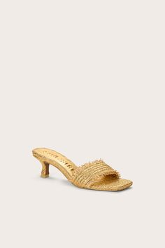 A square-toed open sandal in metallic knit straw with a curved kitten heel. — Metallic knit straw — Comma-heel — Rubber sole — Square toe — 2.36" heel height Metallic Knit, Swimming Bag, Candle Collection, Fragrance Collection, Kids Sandals, Accessories Jewelry Earrings, Kitten Heel, Cozy Fall, Winter White