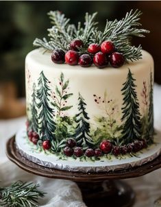 a christmas cake decorated with evergreen and cranberries