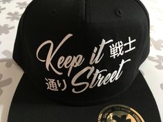 "Information about shipping added to the photos! 5 Panel snapback cap with \"Keep It Street\" print for all Japanese car enthusiasts. Other colours are available at our shop! The cap has size adjuster - one size fits all. The cap is 100% Cotton, and the print is thermo-flock vinyl, white cardboard piece inside of the cap is only for shipping purposes. Free worldwide shipping!" Cheap Black Snapback Hat With Letter Print, Cheap Six-panel Snapback With Letter Print, Cotton Snapback Hat For Streetwear, One Size, 5-panel Baseball Cap For Streetwear, Logo Patch Six-panel Snapback Hat For Streetwear, Logo Six-panel Baseball Cap For Streetwear, Customizable 5-panel Snapback Hat, Black Snapback, Quality Hats