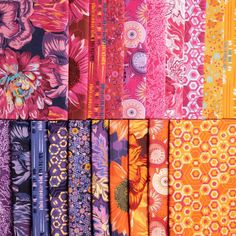 many different types of fabrics are shown in multiple colors and patterns, including oranges, pinks, purples, and reds