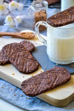 chocolate cookies and milk on a cutting board