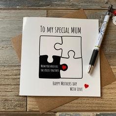 a greeting card with a piece of puzzle on it and a pen next to it