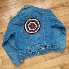 "This piece is a vintage Wrangler Ranch Jacket from the 1970s. This night light blue denim coat has a full button up front, two breast pockets and a beautiful hand made embroidery on the back that was added by a previous owner. The interior of the jacket also has buttons throughout for a lining.  -No Major Stains, Yellowing, or Flaws Tag Size: Size 40, fits like an XS or Small *refer to measurements for true fit* Pit to Pit: 19.5\" Length: 22\" Please also assess the photos and measurements carefully using your own personal judgement as we do not accept returns. Keep in mind that this is a piece of vintage clothing that may hold a residual scent from its past. While we wash all of the clothing we sell (except for certain items which are steam cleaned) we cannot guarantee that we have been Hand Embroidered Denim, Retro Western, Vintage Wrangler, Jeans Button, Cow Boy, Embroidered Denim, Light Blue Denim, Jacket Vintage, Denim Coat