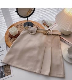 Elegant Beige Belted Skirt, Elegant Beige Skirt With Belt Loops, Chic Beige Skirt With Belt Loops, High Waist Belted Beige Skirt, Belted High Waist Beige Skirt, Chic Solid Beige Skirt, Belted Beige Mini Skirt, Beige Skirt For Office, Beige Belted Mini Skirt