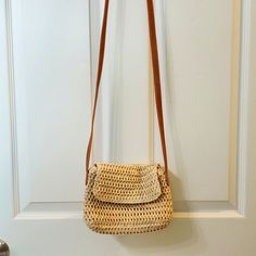 a straw purse hanging on the door handle