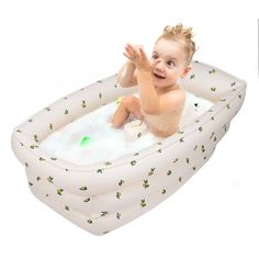 a baby sitting in an inflatable bath tub