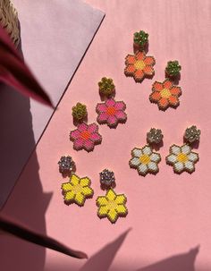 Beautiful, playful earrings with brightly coloured daisies. The perfect feel-good earring!Hand beaded, each pair of earrings takes approximately four hours to create, and is bright, bold and fun!I’ve paired the daisies with bright colourful glass crystals to make them even more of a statement pop of colour.Choose from:hot pink with yellow crystalssunkissed orange with lime crystalstraditional white with clear crystalsor bright yellow with lilac crystals.I designed the FLOWERS collection to add a Playful Handmade Multicolor Flower Earrings, Playful Multicolor Handmade Flower Earrings, Multicolor Beaded Flower Earrings With Flower Charm, Multicolor Flower Shaped Beaded Earrings With Flower Charm, Multicolor Flower-shaped Beaded Earrings With Flower Charm, Yellow Flower Earrings With Colorful Beads, Delica Beaded Earrings, Daisy Earrings, Bead Work Jewelry