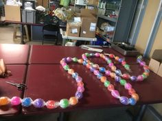 the table is covered with plastic beads and scissors