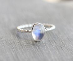 .925 Sterling Silver Ring with 8x6mm genuine rainbow moonstone cabochon. Stackable ring. Band is 1.5mm. This ring is made to order in your size. If you don't see your size available please feel free to message me. All orders ship in a gift box. If you are ordering multiple items and want them boxed separately, please let me know in the notes at checkout. I ship via USPS. Please review the estimated delivery date and processing times. Processing times vary based on how busy my shop is at the time Minimalist Sterling Silver Cabochon Moonstone Ring, Moonstone Oval Cabochon Birthstone Ring, Oval Cabochon Moonstone Birthstone Ring, Sterling Silver Moonstone Ring, June Birthstone Ring, Ring Moonstone, Moonstone Ring Sterling Silver, Moonstone Cabochon, Ring Bezel