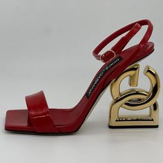 Dolce & Gabbana Keira 105 Dg Logo Heel Square Toe Ankle Strap Sandal Shoes A Gleaming Heel Composed Of Interlocking Logo Letters Heightens The Drama Of This Patent Leather Ankle Strap Sandal With A Square Toe. Patent Leather Upper, Lining And Sole Made In Italy Color: Rosso (Red) With Gold Heel. Size: 36 Eu (Insole: 9", Heel: 4"). Brand New In The Box With A Dust Bag. Designer Ankle Strap Heels With Red Sole, Luxury Red Sole Ankle Strap Heels, Luxury Ankle Strap Heels With Red Sole, Designer Cocktail Sandals With Red Sole, Luxury Heels With Red Sole And Ankle Strap, Luxury Red Sandals For Gala, Designer Red Sandals With Ankle Strap, Designer Red Ankle Strap Sandals, Chic Red Sandals For Gala