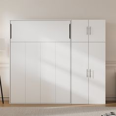 a room with white cupboards and a black lamp on the floor next to it