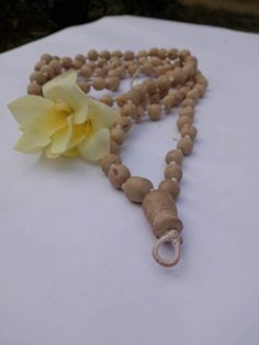 "Introducing our exquisite Tulsi Japa Mala, a sacred accessory designed for meditation and prayer, crafted with utmost care and devotion. This spiritual tool is handcrafted with precision, featuring 108 Spherical beads made from the sacred Tulsi wood. Each bead is a testament to the rich tradition and cultural significance that Tulsi holds in spiritual practices. Mala Length 40 inches. The Tulsi Japa Mala boasts a unique design, with its Spherical beads gradually decreasing in size from a substantial bead size of 2 cm to a smaller, delicate size of 1.5 cm. This meticulously crafted arrangement not only enhances the aesthetic appeal of the Mala but also ensures a comfortable grip and smooth touch, allowing your fingers to glide over the beads effortlessly during your meditation and prayer s Bohemian 108 Beads Mala For Blessing, Bohemian Mala With 108 Beads For Blessing, Spiritual Mala With 108 Beads For Blessing, Hand-strung Spiritual Beads For Blessing, Spiritual Wooden Beads Mala For Meditation, Handmade Spiritual Mala, Spiritual Wooden Beads Jewelry For Meditation, Adjustable Bohemian Mala For Blessings, Handmade Spiritual Mala For Rituals