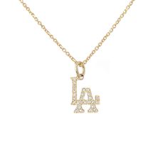 This detailed classic Los Angeles logo charm pendant is composed of 14K solid gold and finished with GVS1 quality natural real diamonds covering the entire surface. This charm is beautifully complemented by a durable yet delicate 14K solid gold adjustable chain, finished with a secure lobster claw clasp and Nana Bijou signature logo tag. This charm is also available to be purchased as a charm alone without the chain. LA Pendant Dimensions (not including the bail): approximately 6mm (w) x 7mm (h) Luxury Gold Charm Necklace With Logo, Luxury White Gold Necklace With Logo Charm, Luxury White Necklace With Logo Charm, Luxury White Necklaces With Logo Charm, Luxury Gold Chain Necklace With Logo Charm, Channel Necklace Logo Gold Pendant, Luxury Logo Charm Necklaces, Luxury Logo Charm Necklace, Luxury Sterling Silver Necklace With Logo Charm