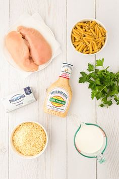 ingredients to make chicken parmesan casserole laid out on a white table