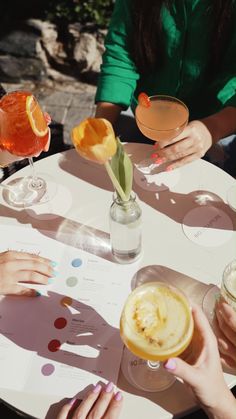 four people sitting at a table with drinks