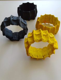 three different types of rubber bands sitting on a white table next to an orange and black one