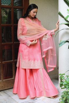 Pink kurta in organza base with gota work hand embroiery. Paired with sharara in chanderi base and a net and organza dupatta.
Components: 3
Pattern: Embroidered
Type Of Work: Gota
Neckline: Round
Sleeve Type: Full
Fabric: Organza, Chanderi, Lining: Shantoon
Color: Pink
Other Details: 
Side slits
Sheer dupatta
Occasion: Wedding - Aza Fashions Designer Organza Sharara With Straight Kurta, Semi-stitched Sharara With Sheer Dupatta And Straight Kurta, Wedding Raw Silk Palazzo Set With Gota Work, Wedding Palazzo Set With Gota Work In Raw Silk, Wedding Organza Palazzo Set For Festive, Wedding Organza Palazzo Set, Festive Wedding Organza Palazzo Set, Festive Sharara With Zari Work In Organza, Transitional Organza Salwar Kameez With Cutdana Details