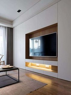 a living room with a large flat screen tv mounted to the side of a wall