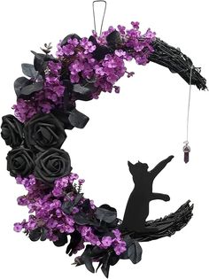 a wreath with flowers and a cat hanging from it's front end, on a white background