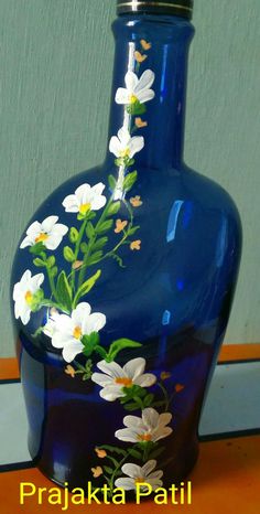 a blue vase with white flowers painted on it