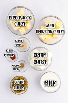 four bowls filled with different types of cheese and some type of cream on top of them