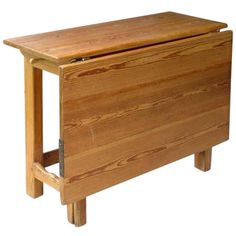 a wooden cabinet with two legs and a drawer on one side, in the shape of a chest