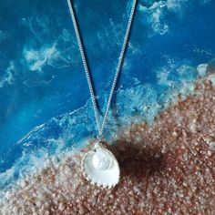 Embrace the beauty of the ocean with our handcrafted Seaside Elegance necklace, a stunning piece that captures the essence of the shore. This necklace features a natural seashell pendant, carefully selected for its unique shape and intricate patterns, paired with a lustrous freshwater pearl that adds a touch of elegance. Each necklace is lovingly handcrafted, ensuring that no two pieces are exactly alike--just like the treasures you find on the beach. The combination of organic elements and timeless pearls creates a perfect harmony, making this necklace a versatile accessory that can complement any outfit, whether you're dressing up for a special occasion or adding a touch of coastal charm to your everyday look. Features: Natural Seashell: Handpicked for its distinctive beauty, bringing th Ocean-inspired Pearl Charm Jewelry For Beach, Beach Pearl Necklace With Pearl Pendant, Pearl Pendant Necklace For Beach, Beach Shell Shaped Pearl Pendant Jewelry, Shell-shaped Pearl Pendant For Beach, Shell Shaped Pearl Pendant For Beach, Ocean-inspired Strand Necklaces For Jewelry Making, Beach Shell Pendant Necklace With Pearl Charm, Beach Necklaces With Pearl Pendant