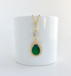 I've create this luxurious green emerald cubic zirconia bridal teardrop set in gold plated brass setting. This set includes: #Earrings feature a large teardrop with pear cut green emerald cubic zirconia center surrounded by tiny round zirconia crystals. Teardrop dangles from a earstud with brilliant cut red ruby cubic zirconia center and surrounded by tiny round zirconia crystals and a round cubic zirconia connector. Total length of the earring is 4.8 cms. #Necklace pendant features a large tear Emerald Pear-shaped Necklace For Wedding, Emerald Pear-shaped Wedding Necklaces, Emerald Teardrop Pendant Necklace For Weddings, Gold Plated Teardrop Pendant Jewelry For Wedding, Gold Plated Teardrop Pendant For Wedding, Emerald Teardrop Pendant For Wedding, Green Teardrop Pendant Necklace For Wedding, Green Drop Jewelry For Wedding, Teardrop Cubic Zirconia Jewelry For May Birthstone