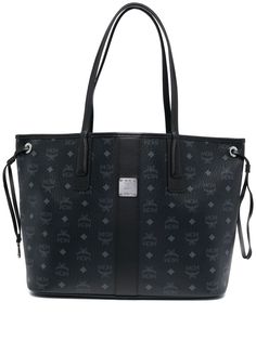 medium Liz reversible tote bag from MCM featuring black, canvas, coated finish, leather trim, monogram print, all-over graphic print, silver-tone logo plaque, reversible, circular top handles, open top, drawstring fastening and removable pouch. | MCM medium Liz reversible tote bag Black Mcm Bag, School Purse, Mcm Purse, Tote Bags For School, Reversible Tote Bag, Goyard Bag, Mcm Bags, Girly Bags, Reversible Tote